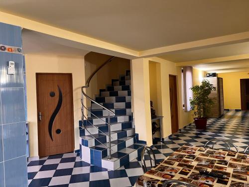 a room with a staircase and a tiled floor at Vila Ovi Salin in Turda