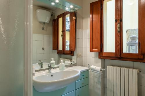 a bathroom with a sink and a mirror at I Fossi Apartment - Lucca in Lucca