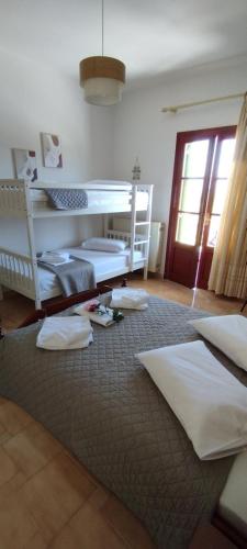 a bedroom with two beds and a large rug at SERENITY Apartments 1 in Vathi, Ithaka