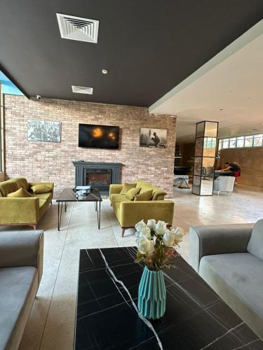 a living room with couches and a fireplace at Apartment in Gonio - PONTOS ROOMS in Itʼkhvisi