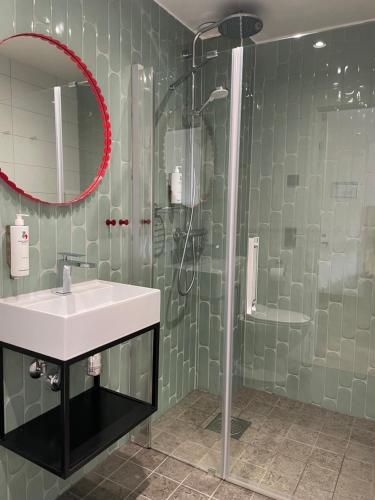 a bathroom with a sink and a shower at Good Morning Karlstad City in Karlstad