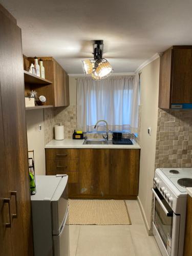 a small kitchen with a sink and a window at Harmony in Mytilini