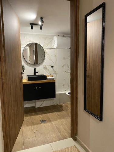 a bathroom with a sink and a mirror at Harmony in Mytilini