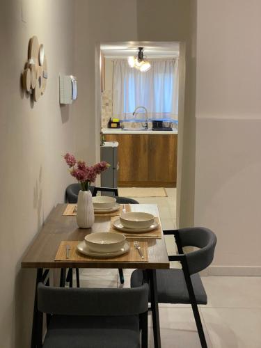 a dining room table with chairs and a kitchen at Harmony in Mytilini