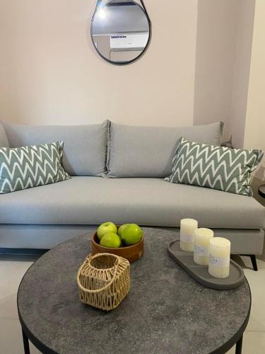 a living room with a couch and a table with apples at Harmony in Mytilini