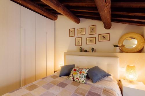 a bedroom with a bed and a mirror on the wall at Winding Village Suite in Trevi