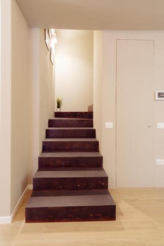 a stairway in a room with a stair case at Winding Village Suite in Trevi