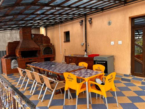 a patio with a table and chairs and a fireplace at Vila Ovi Salin in Turda