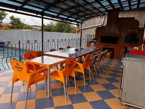 a table and chairs on a patio with a fireplace at Vila Ovi Salin in Turda