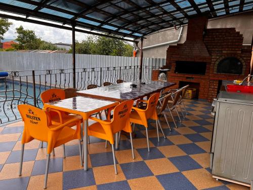 a table and chairs on a patio with a fireplace at Vila Ovi Salin in Turda
