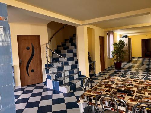 a room with a table and a checkered floor at Vila Ovi Salin in Turda
