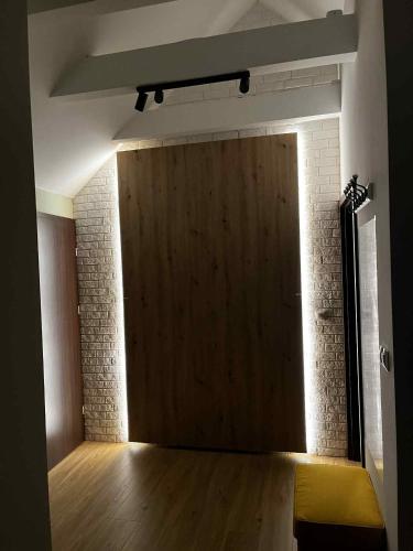 a large wooden door in a room with a wooden floor at Apartamenty Rubikon in Kraków