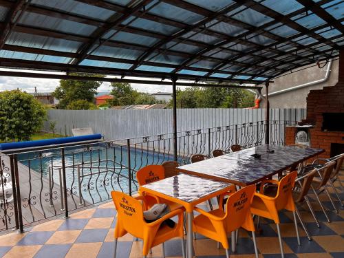 a patio with a table and chairs and a pool at Vila Ovi Salin in Turda