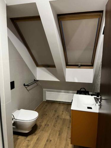a bathroom with a toilet and a sink at Apartamenty Rubikon in Kraków