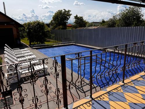 a swimming pool on a balcony with chairs at Vila Ovi Salin in Turda