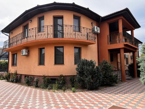 a large house with a balcony on top of it at Vila Ovi Salin in Turda