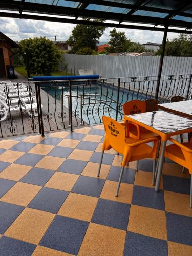 a patio with a table and chairs and a pool at Vila Ovi Salin in Turda