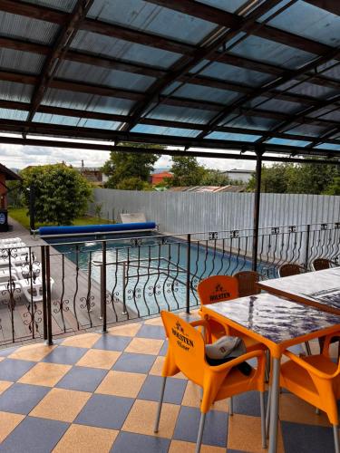a patio with a table and chairs and a pool at Vila Ovi Salin in Turda