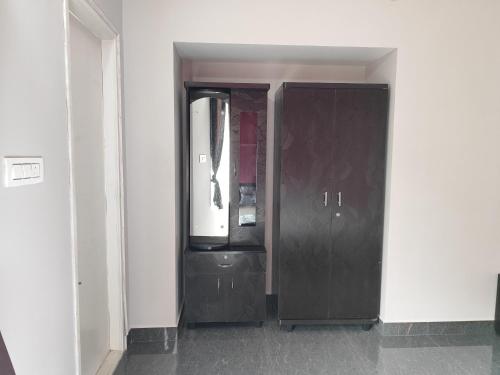 a black cabinet with a tv in a room at Samuels Comfort Homes in Bengaluru