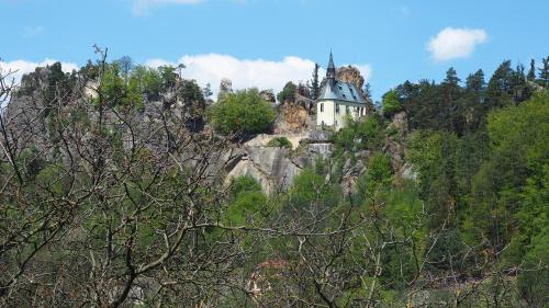 a house on top of a mountain with trees at Holiday House Malá Skála in Malá Skála