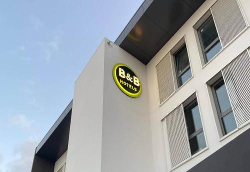 a gas station sign on the side of a building at B&B HOTEL La Réunion Aéroport in Sainte-Marie