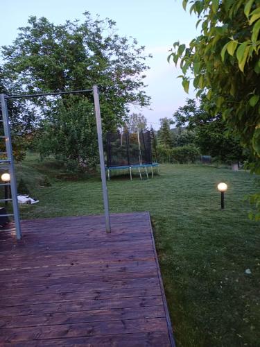 an empty swing set in a park with a field at Villa Villekulla in Chukovezer