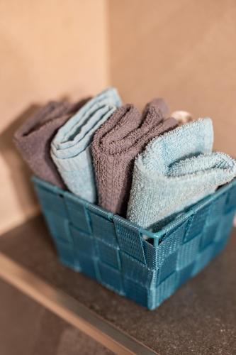 a basket of towels sitting on a table at Adlerhof in Samerberg