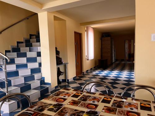 a room with a table and a checkered floor at Vila Ovi Salin in Turda