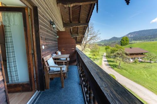 a balcony with chairs and a table on a house at Adlerhof in Samerberg