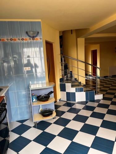 a room with blue and white checkered floor and stairs at Vila Ovi Salin in Turda