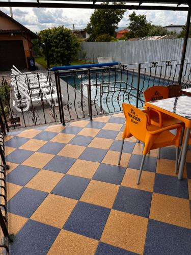 a patio with a table and chairs and a pool at Vila Ovi Salin in Turda