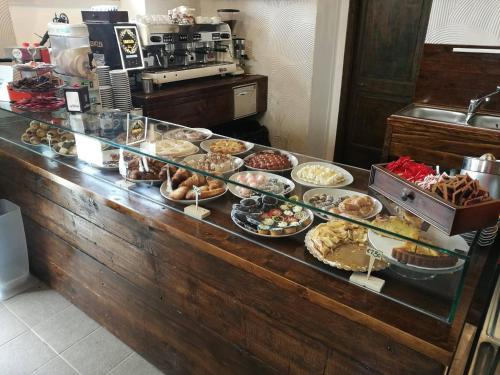 a buffet line with many different types of pastries at La Locanda della Mandria in Venaria Reale