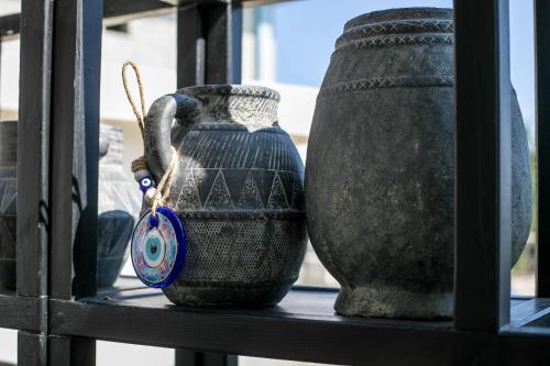 two vases sitting on a shelf next to each other at Olevia Comfort in Faliraki