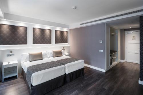 a bedroom with a large bed in a room at Catalonia Magdalenes in Barcelona