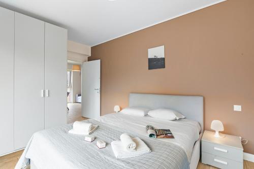 a bedroom with a large bed with white pillows at Viganello Modern Apartments in Lugano