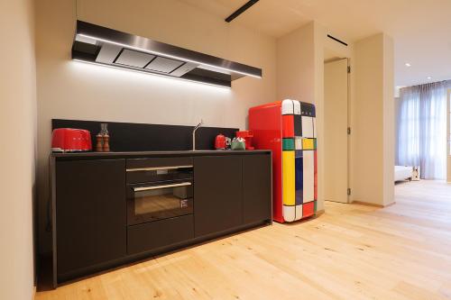 a kitchen with a black counter and a refrigerator at Villa Amelia in Orta San Giulio