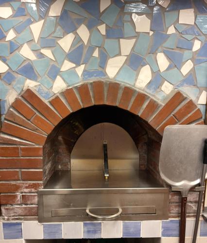 a brick oven with a mosaic tile wall at Vincanto Maiori Costiera Amalfitana in Maiori