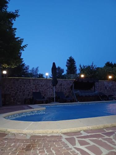 a swimming pool in a backyard at night at Villa Villekulla in Chukovezer