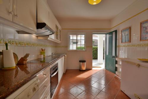 a kitchen with a sink and a counter top at Villa 3 Quartos, BBQ, Terraço, Praia, Prestige For Home in Castro Marim