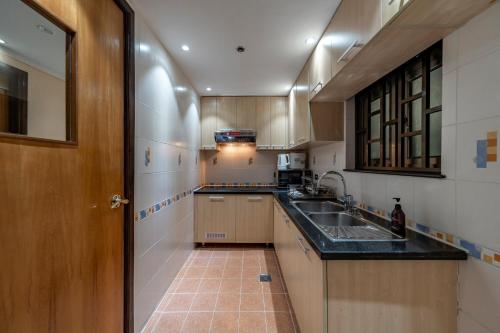 a kitchen with a sink and a counter top at Sherwood Residence in Ho Chi Minh City