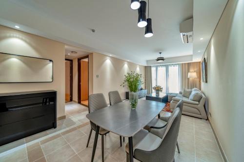 a dining room and living room with a table and chairs at Sherwood Residence in Ho Chi Minh City