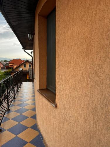 a building with a window and a checkered floor at Vila Ovi Salin in Turda