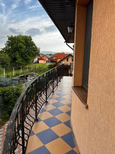 a balcony of a building with a checkerboard floor at Vila Ovi Salin in Turda