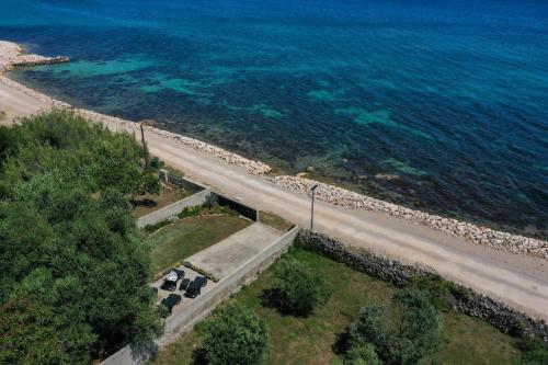 an aerial view of a road next to the ocean at House Ana in Banj