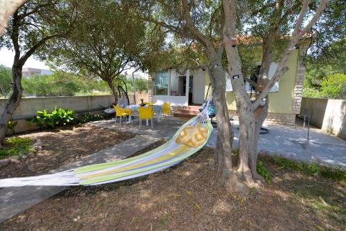 a hammock in a yard next to a house at House Ana in Banj
