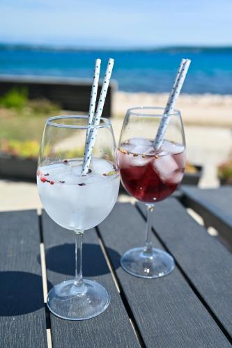 two glasses of wine sitting on top of a table at House Ana in Banj