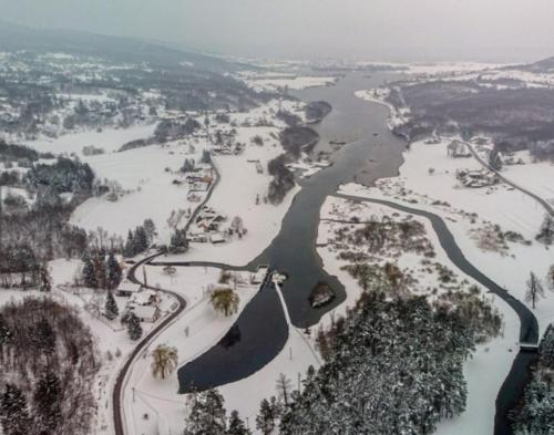 an aerial view of a river in the snow at Lumaris in Ogulin