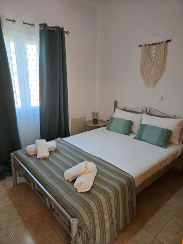 a bedroom with a large bed with towels on it at Nora Apartment in Almyrida in Chania Town