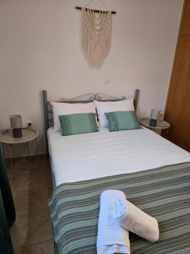 a bedroom with a bed with a sock on it at Nora Apartment in Almyrida in Chania Town