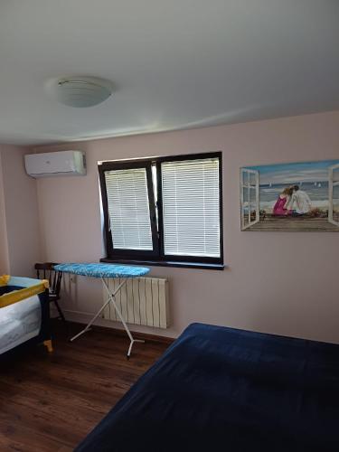 a bedroom with a bed and a window and a table at Villa Villekulla in Chukovezer